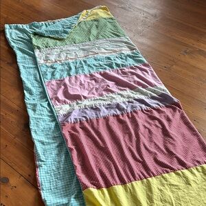 The Land of Nod patterned duvet cover, down duvet, and throw pillows